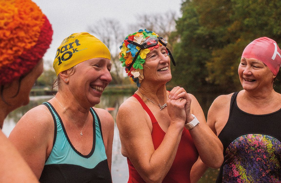 Outdoor swimmers wearing colourful hats.